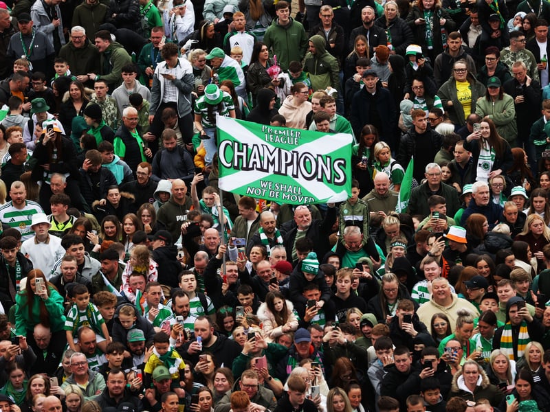 The Celtic fans greet the first team squad at the stadium.