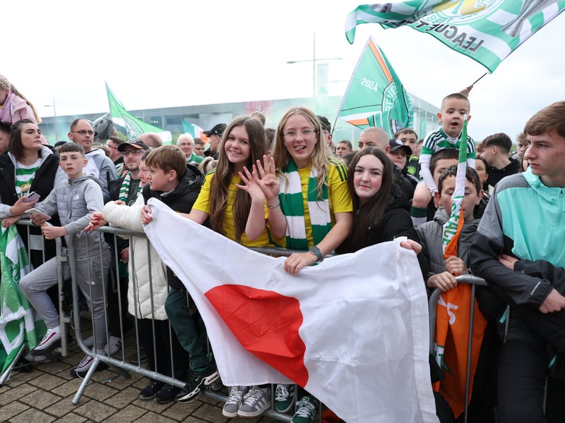 Two Celtic fans hold up a Japanese flag in honour of their star Japanese duo.