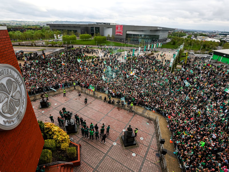 The Celtic fans greet the first team squad and management outside the stadium.