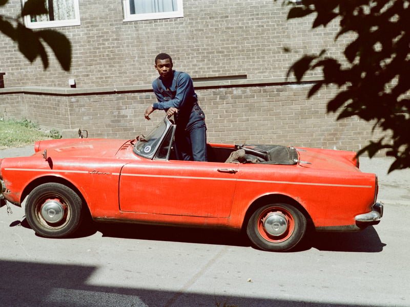 Roy Lewinson outside Cunliffe Villas in Manningham with his Sunbeam Alpine Mix 5.