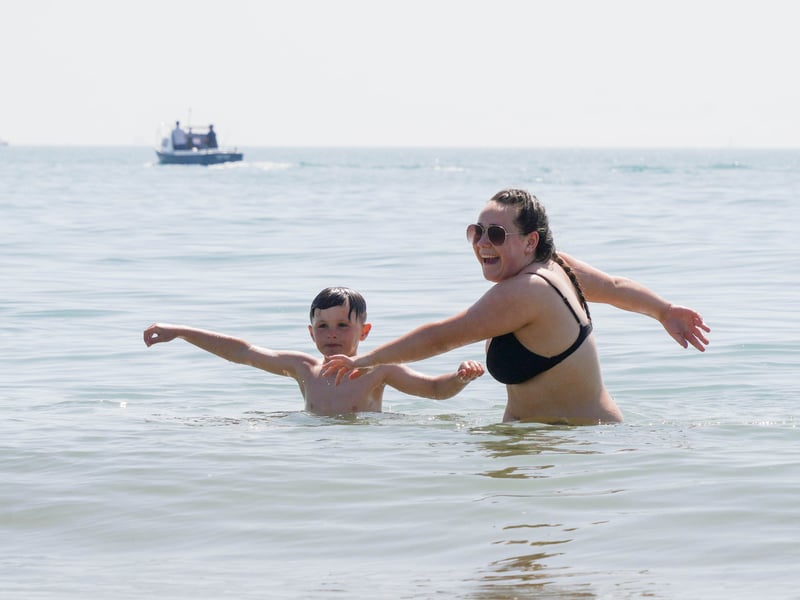 Hot weather pictures in Southsea, Portsmouth 

Pictured: Ralhie Elliott playing in the sea with May 

Picture: Jack Oliver