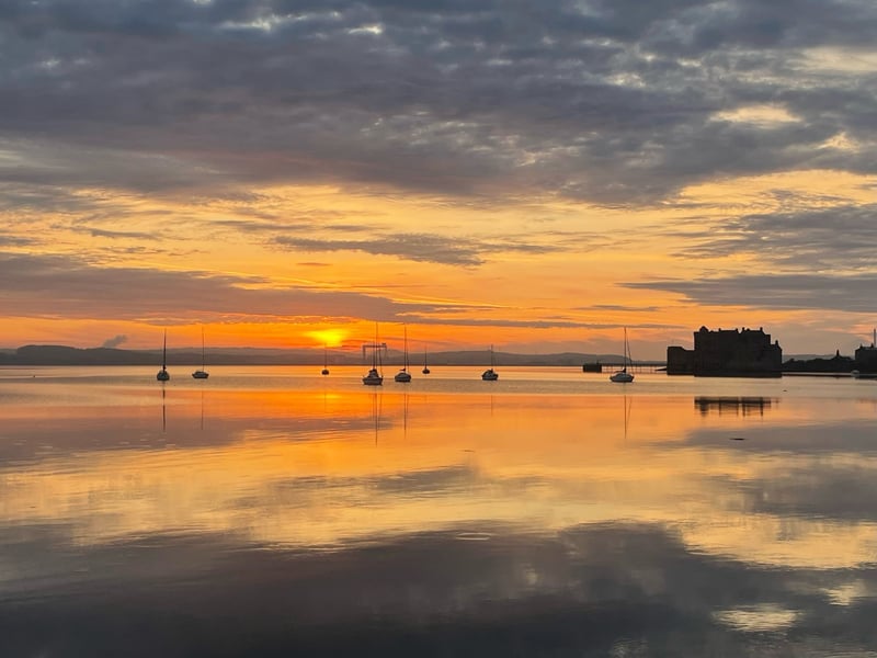 The sun rises over the River Forth in a view from the village of Blackness.