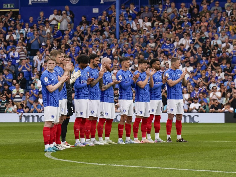 The Pompey players and fans stand side by side to applaud those supporters who have passed away over the course of the season.