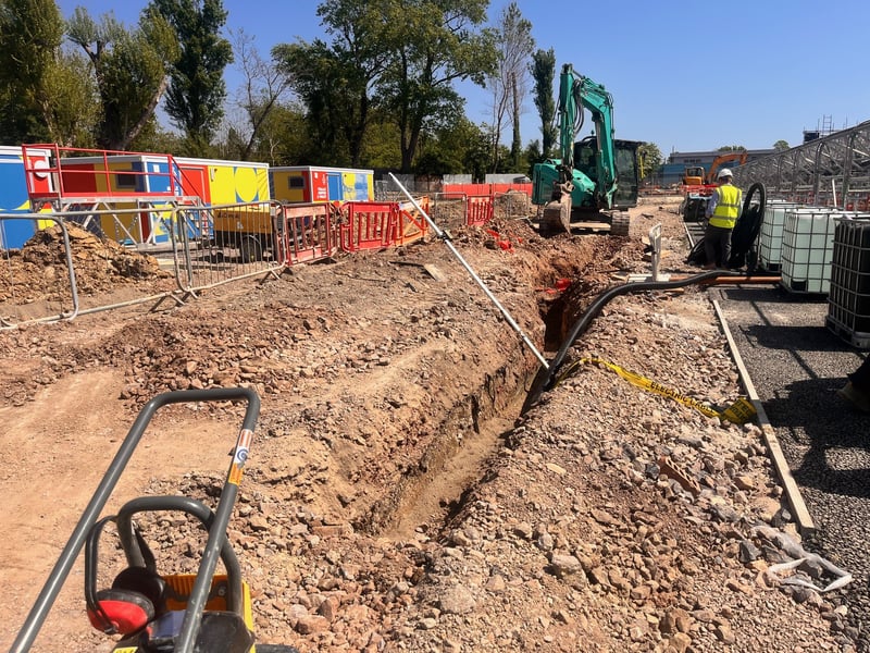 The contractors are preparing this area for the final surface. In this photo you can see a trench being dug out - this is for electric cables, so the plant room has electricity.
