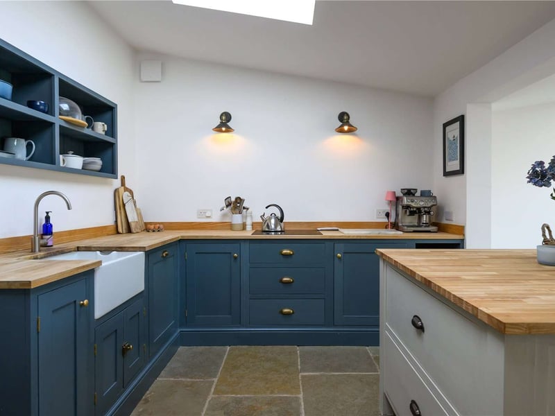 The kitchen has modern shaker style cabinets and plenty of storage.