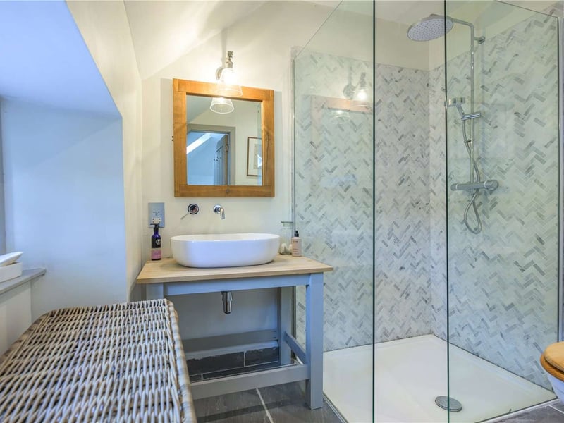 One of the bathrooms is a modern shower room.