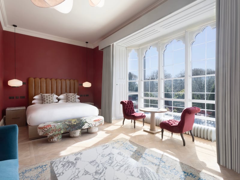 A junior suite with seating area and views of the grounds.
