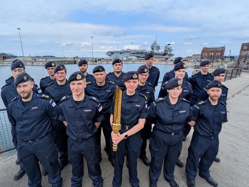 Pictured: Crew from HMS Queen Elizabeth with the Torch for Peace 