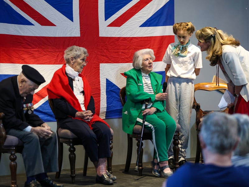 The Portsmouth Historic Dockyard hosted a VE day event  where veterans were interviewed about their wartime memories. 

Pictured: Charlotte, 12, asking a question. 
From left, Robin Boodle who was an able seaman in the Battle of The Atlantic, Mabel Kidney of the WRNS and Dorothy Walsh who worked at Bletchley Park with Alan Turing on the Enigma machine. 

Picture: Chris Moorhouse (100525-33)
