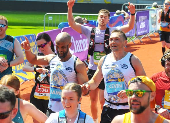 Jamie Jones-Buchanan and Kevin Sinfield reach the finish line to cheers from the crowds.