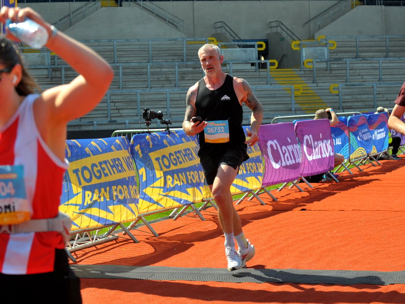 Former Leeds Rhinos player Jamie Peacock crosses the finish line.