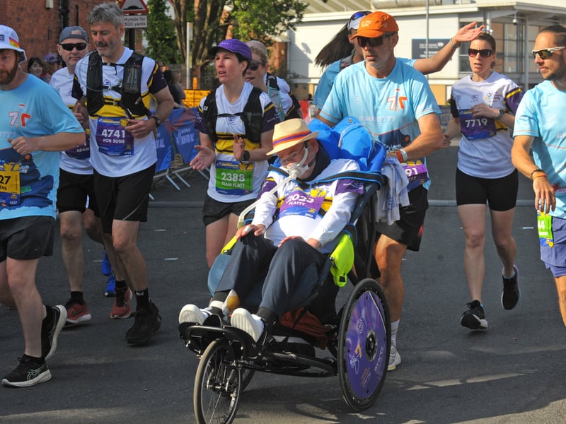 Ian Flatt, of York, who is living with MND, was pushed round the course by Team Flatt.