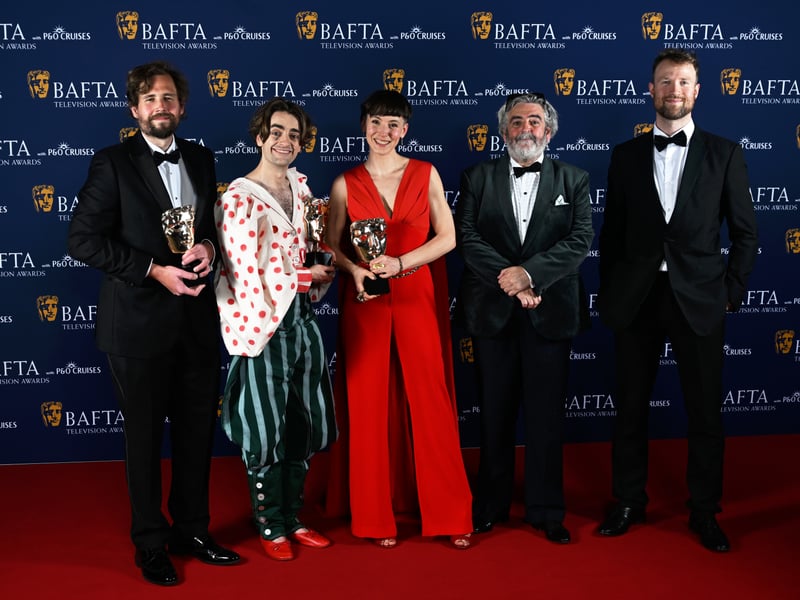 Alex Bruce, Luke Rollason, Ruth Pickett and members of the cast and crew pose with the Short Form Award for 'Quiet Life' inside the Winners Room at the 2025 BAFTA Television Awards.