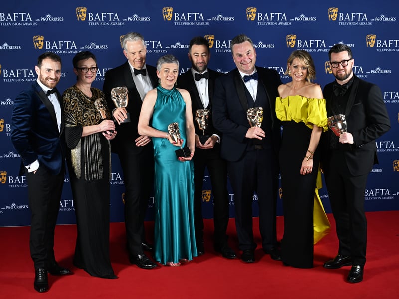 Martin McCann, Louise Gallagher, Stephen Wright, Amanda Black, Adam Patterson, Declan Lawn, Sian Brooke and Jack Casey pose with the Drama Series Award for 'Blue Lights' inside the Winners Room at the 2025 BAFTA Television Awards.