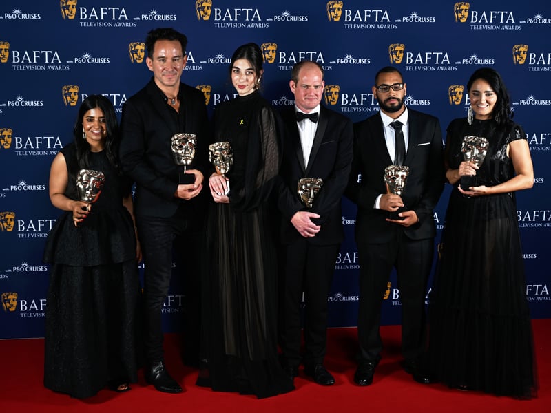 Ahisha Ghafoor, Marcel Metteisiefen, Mayte Carrasco and members of cast and crew pose with the Current Affairs Award for 'State of Rage' inside the Winners Room at the 2025 BAFTA Television Awards.