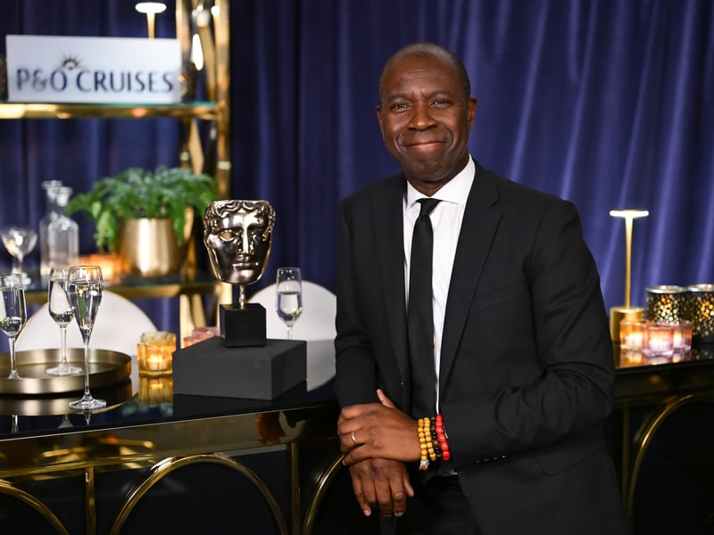 Clive Myrie poses with the Daytime Award for 'Clive Myrie's Caribbean Adventure' in the winners room at The BAFTA Television Awards