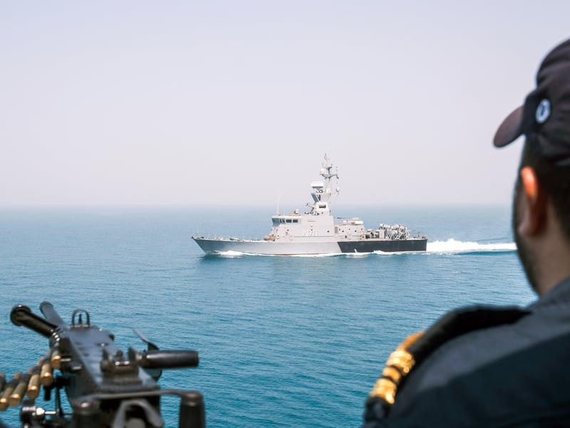 HMS Middleton’s CO Lt Cdr Kyle O’Regan watches as Kuwaiti patrol craft KNS Ouha sails past
