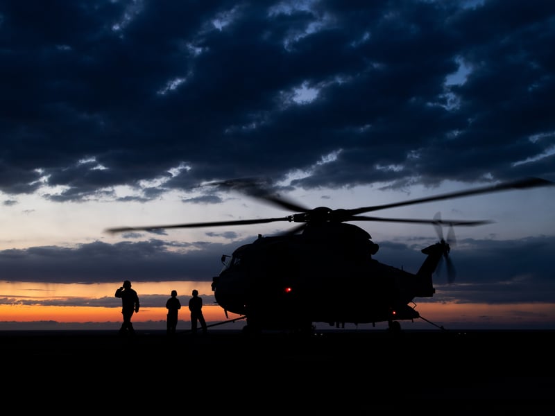 Pictured: A Merlin Mk2 Helicopter from 820 Naval Air Squadron silhouetted on the flight deck of HMS Prince of Wales during night flying operations for Exercise Med Strike during Operation Highmast as part of the UK Carrier Strike Group 2025.
