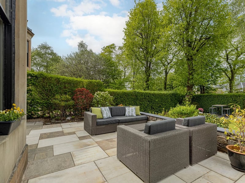 A paved seating area in the garden.
