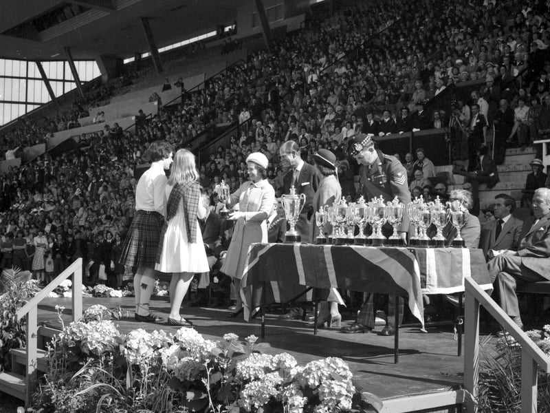 The Queen presents awards to school children as she and Prince Philip attend the Scottish Youth Pageant held at Meadowbank during the Silver Jubilee celebrations in May 1977. 
