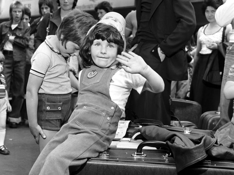 Waiting at Edinburgh's Waverley Station to go on holiday in July 1976, little Jane Garden discovers her sand bucket doubles as a sunhat.