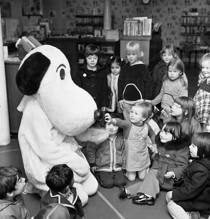 'Snoopy' with children and toddlers in the junior section of Central Library in George IV Bridge Edinburgh to promote the Children's Book Bang event in May 1976.