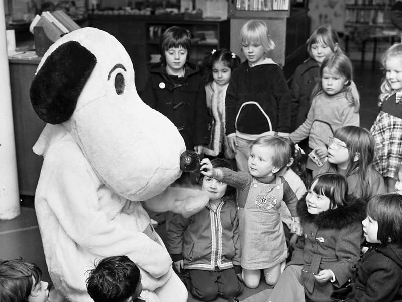 'Snoopy' with children and toddlers in the junior section of Central Library in George IV Bridge Edinburgh to promote the Children's Book Bang event in May 1976.