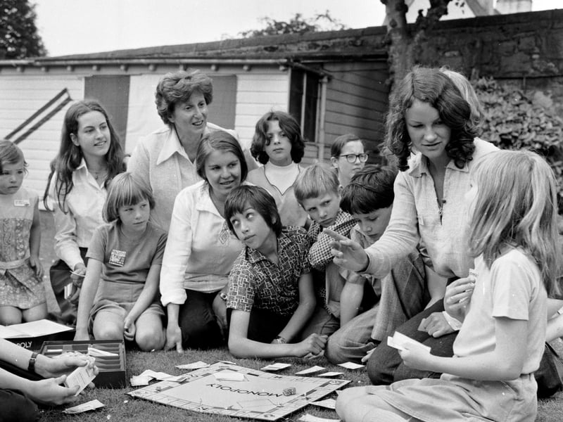 A game of Monopoly is used to help teach French at the Grange children's home school in July 1976.