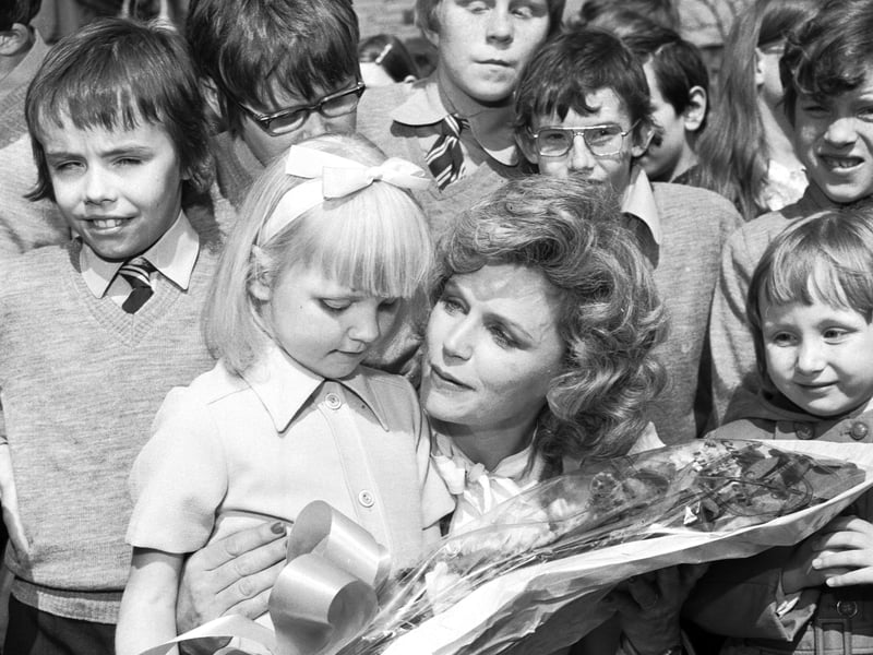 American actress Lee Remick is given a bouquet of flowers  by five-year-old Kirsten Beaton after she presented a new Evening News Charity mini-bus to the children of the Royal Blind School Edinburgh in May 1976. The money for the bus was raised by the Evening News Charity Walk.