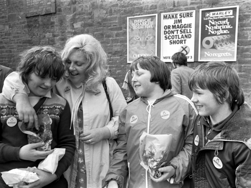 SNP politician Margo MacDonald gets a chip from local boys during her visit to Gorgie, Edinburgh, in April 1979.