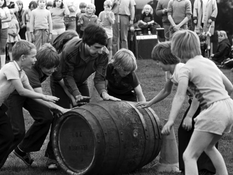 Boys take part in a barrel race in It's a Knockout at the Craigmillar Festival in Edinburgh in August 1978.