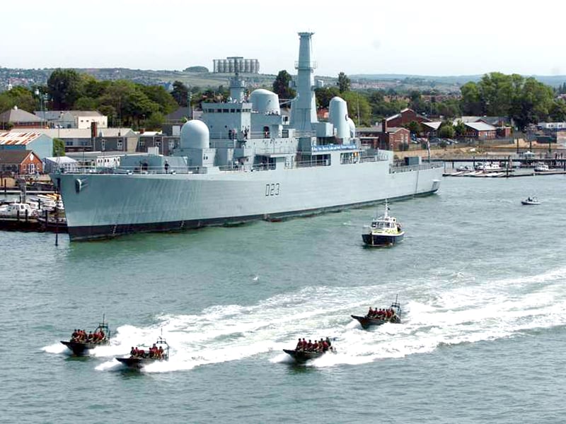 HMS Bristol, a Falklands War Royal Navy Destroyer, has been a long term fixture in Portsmouth over the years. Pictured: Royal Marine Commandos in Rigid Raiders pass HMS Bristol in Portsmouth harbour during a rehearsal for media for Trafalgar 200 in 2005.