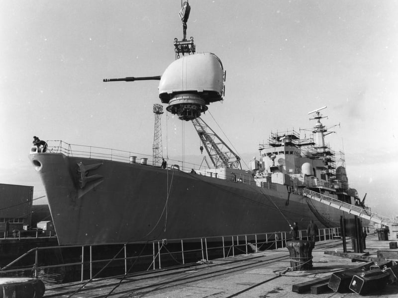 A gun is lowered onto HMS Bristol in 1985