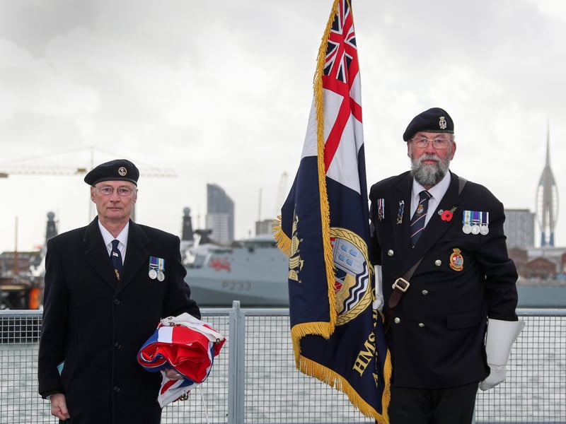 Peter Featherstone Williams, veteran and chairman of the Bristol Association and Dick Shanton, HMS Bristol's Standard Bearer, receiving the white ensign that was lowered for the last time.