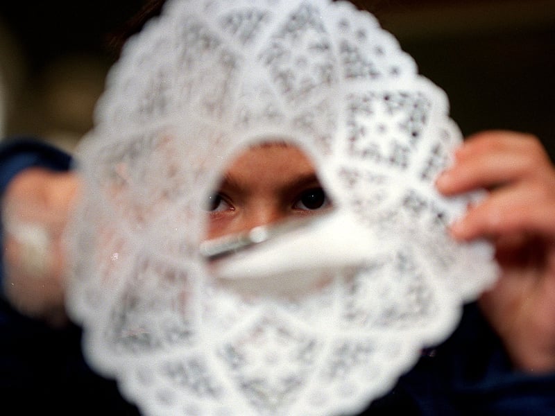Robert Ellis makes a snowflake during a Christmas activity day at the Pump Rooms in December 1999.