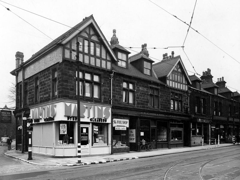 Shops on the north east side of Otley Road pictured in October 1942. Among them left to right are Martins Dyers and Cleaners, The fuel Shop, G. Cook & Son, P & M Hairdressers, Barclays Bank, G. Arthur Bartram and Cliffords. There is a sign on the right saying Harold Wray, plumber & electrician. The corner of Wood Lane is visible to the left of the photo.