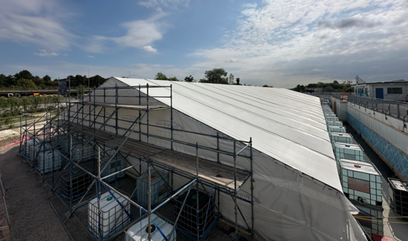 The tent is now fully installed, providing protection for the pool from the weather.