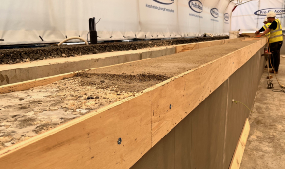 Inside the tent - The team are currently screeding the top edges of the pool to create a level surface for the tiles.