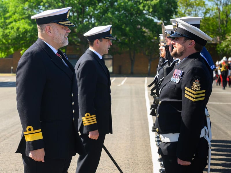 The Royal Navy Rear Admiral inspecting the guard at HMS Collingwood in Fareham during a visit.