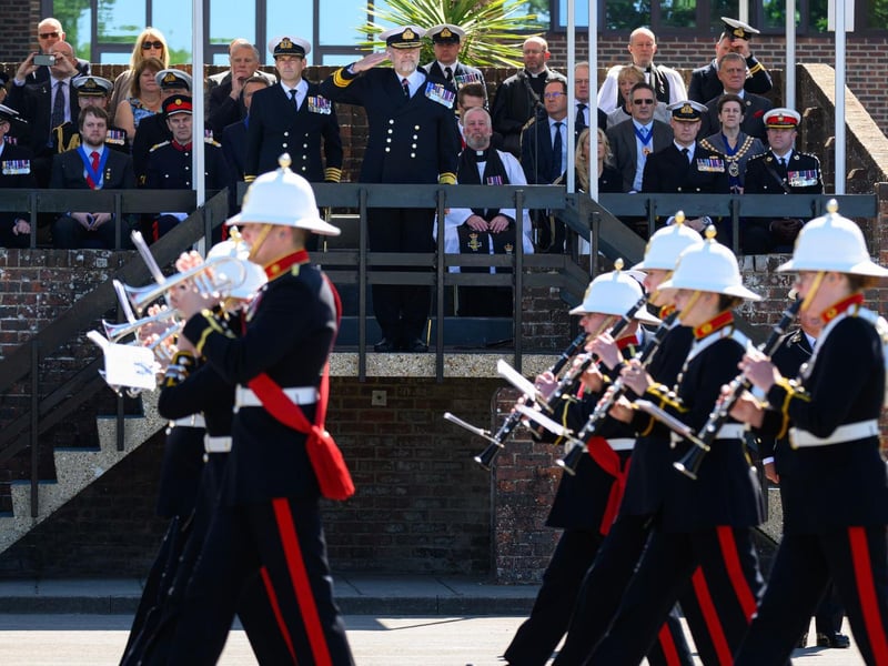 The Royal Marines Band Service carrying out a march past for the Royal Navy Rear Admiral.