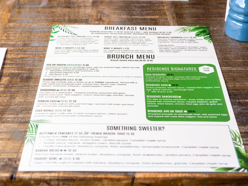 The evening menu features a variety of small plates from crispy arancini and baked meatballs to creamy Burrata with pesto, perfect for sharing.