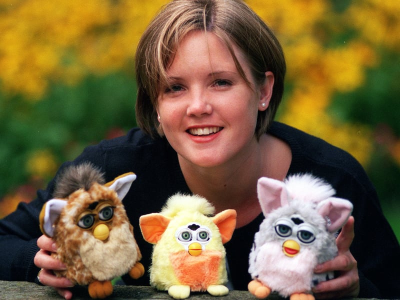 Emma Carle of Tiger Electronics with a 'mummy and daddy' Furby and one of the new Furby Babies, centre. Pictured in August 1999.