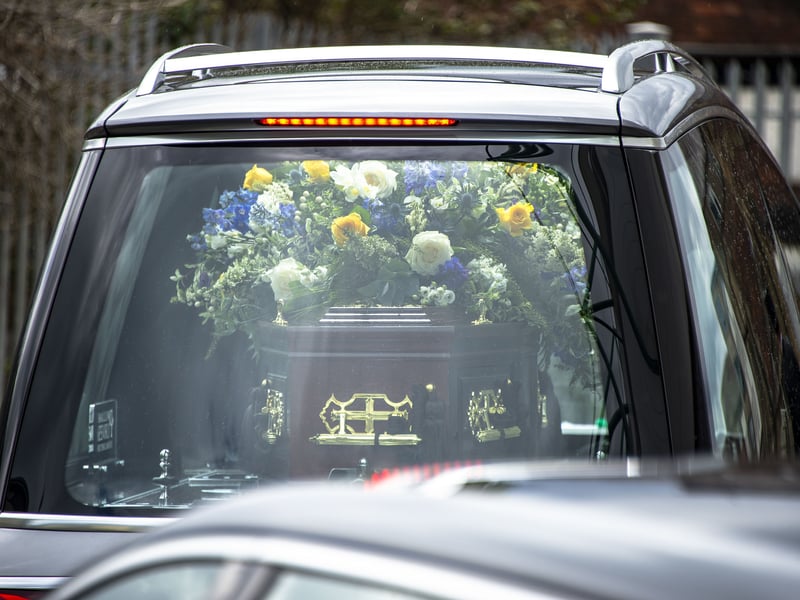 The coffin carrying Sir Tom Farmer's body could be seen through the hearse's windows.