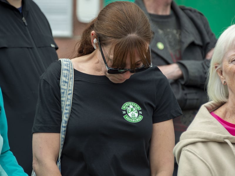 Members of the public, Hibs supporters and Hibs staff pay their respects as the hearse of Sir Tom Farmer drives past Easter Road Stadium.