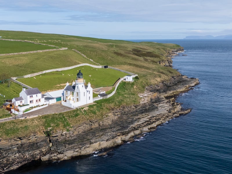 Holborn Head lighthouse stands in an outstanding setting with elevated views over Scrabster beach in Caithness over to Dunnet Head, Orkney and the Old Man of Hoy.