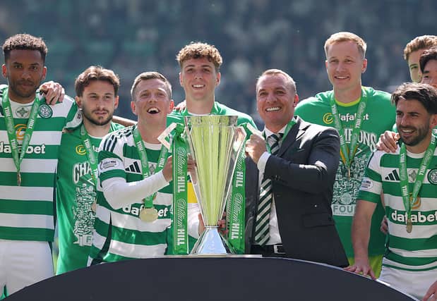 Callum McGregor and Celtic manager Brendan Rodgers lift the Scottish Premiership trophy at Celtic Park following the game against St Mirren last season. Cr: Getty Images.