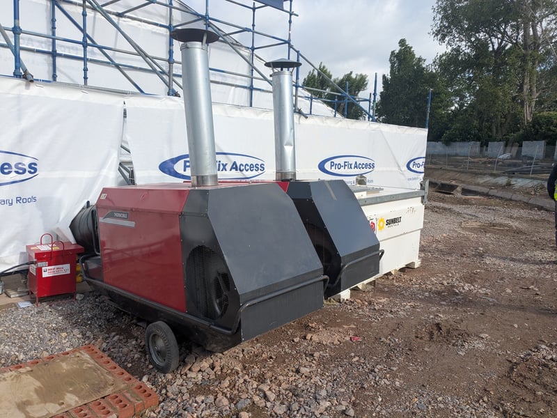 Outside the tent are two industrial heating units which are standing by, ready to kick in and pump warm air inside if the temperature drops below 8°C.
When it’s warmer than that, they provide unheated ventilation to help the render and grout dry inside the tent.