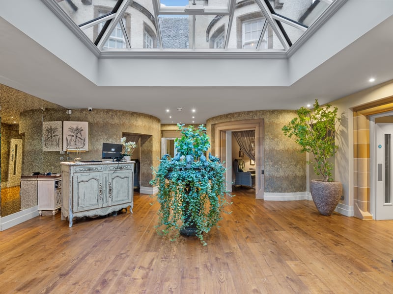 Upon entering through the glass vestibule, guests are greeted by a grand entrance hall where the turret space is cleverly used for private dining.