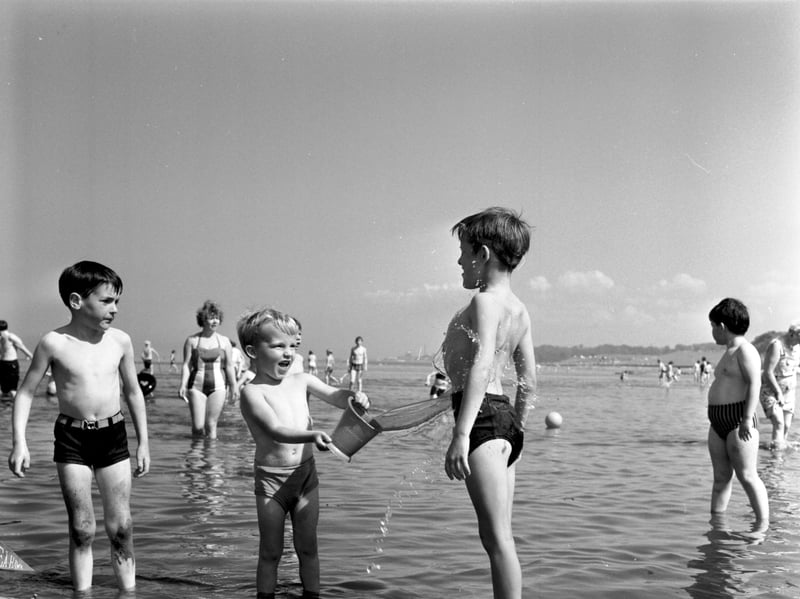 A wee boy splashes another youngster with water at Cramond, Edinburgh, in August 1970