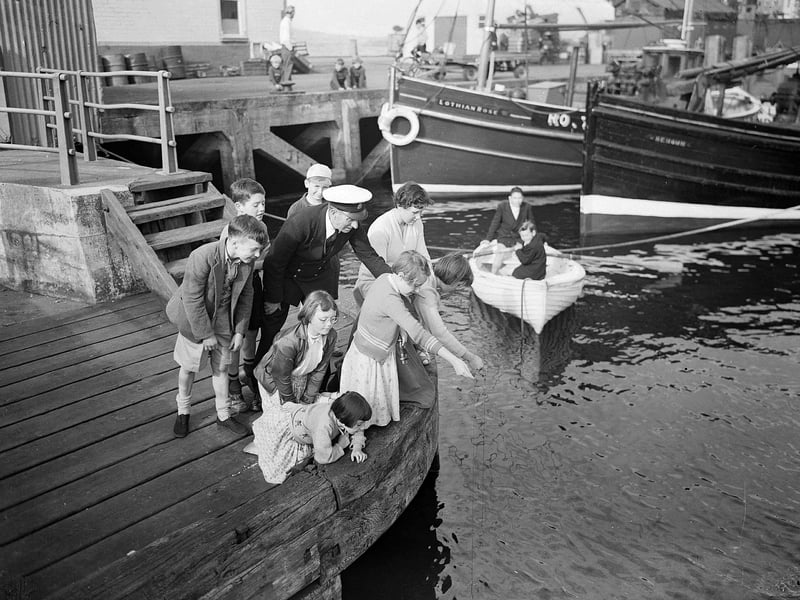 Children at fishing at the quay during the Glasgow Fair holiday in July 1956